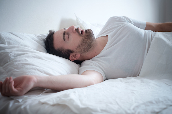 Man snoring in bed